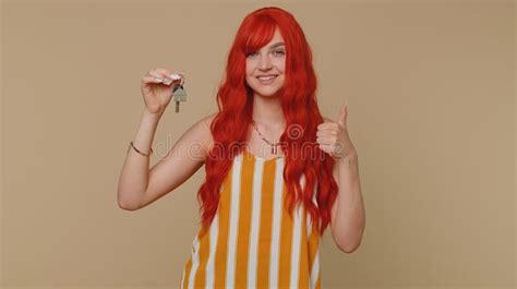 redhead woman real estate agent show keys of new home house apartment buying property mortgage