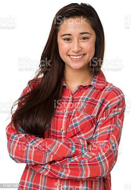Portrait Of Smiling Teenage Girl With Arms Crossed Stock Photo
