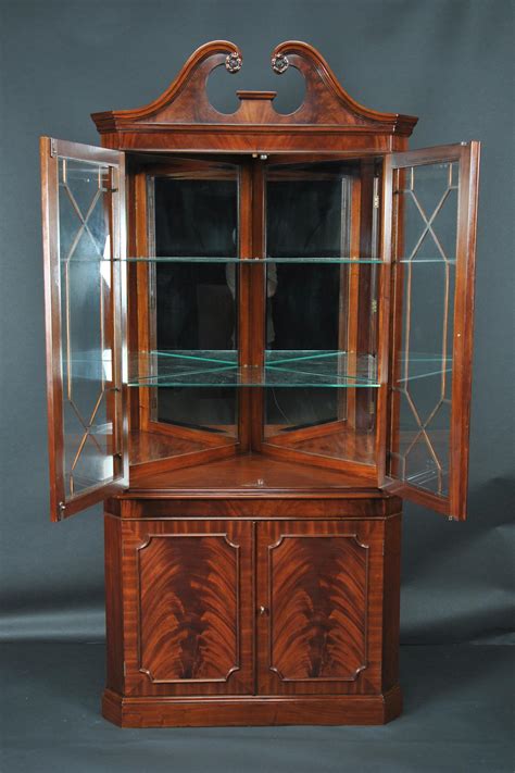 The tongue and groove detailing provides a stylish backdrop for your favorite display pieces, complemented by simple black metal hardware. Mahogany Corner China Cabinet | Corner Hutch | Corner Curio