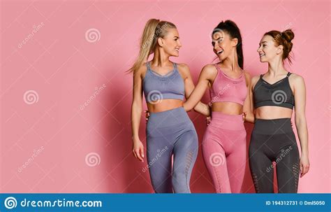 Group Of Three Sport Girls International Friends Posing On Pink