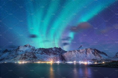 Aurora Borealis Over The Sea Snowy City Lights At Night Aurora