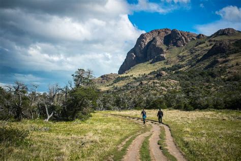 Two Men Walking Along Path To Mountains Stock Photos Free And Royalty