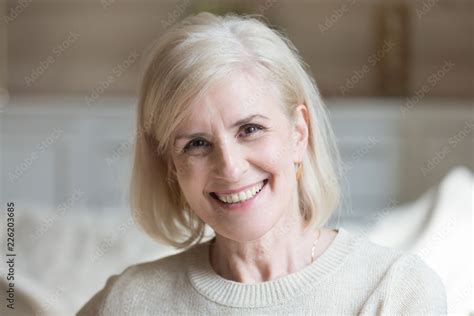 Happy Middle Aged Elderly Grey Haired Woman Looking At Camera Posing At
