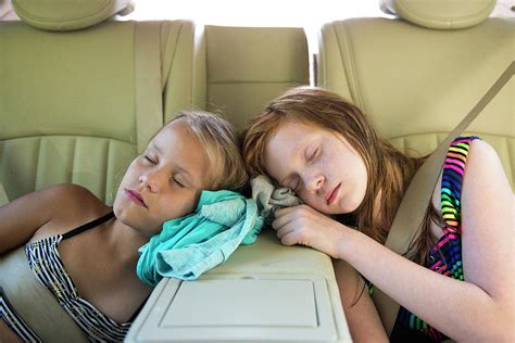 Two Young Girls Asleep In Car After Playing Photograph By Cavan Images