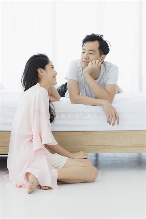 Asian Couple In Pajamas Sit In Bedroom Stock Image Image Of House