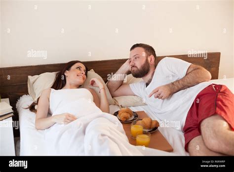 Husband And Wife Wake Up In The Morning In The Bedroom Weekend