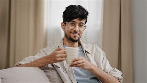 Arabic Bearded Millennial Man Latin Guy In Glasses Sitting At Home