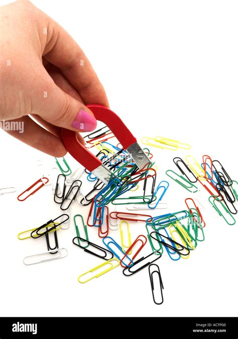 Magnet Picking Up Paperclips Stock Photo Alamy