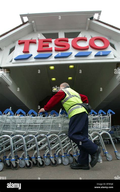Man Collecting Shopping Trolleys At A Tesco Supermarket Picture Bu