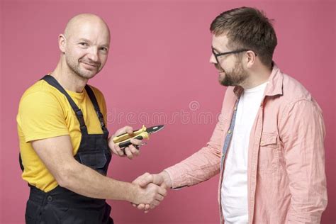 Grateful Client Makes A Handshake Gesture With A Worker Who Did A Good