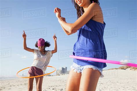 Women On Beach Using Hula Hoops Stock Photo Dissolve