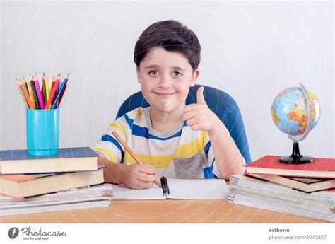Smiling Boy Studying Sitting On A Chair A Royalty Free Stock Photo