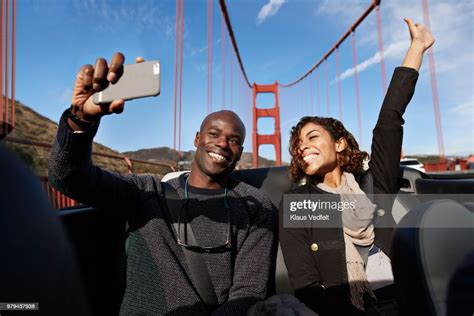 Laughing Couple Making Selfie On The Back Seat Of Convertible Car High