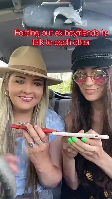 Two Beautiful Women Sitting In The Back Seat Of A Car