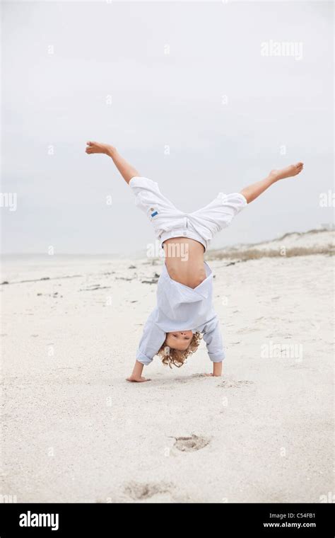 Boy Doing Handstand On Beach Stock Photo Alamy