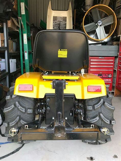 A Yellow Four Wheeler Parked In A Garage