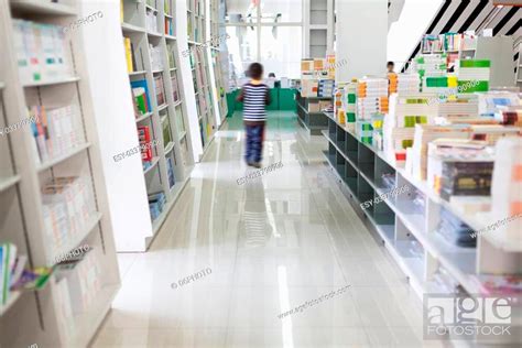 The Aisles In A Public Library With Shelves Full Of Books Stock Photo