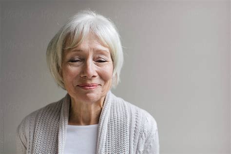 Studio Portrait Of Senior Woman On Simple Grey Background Del