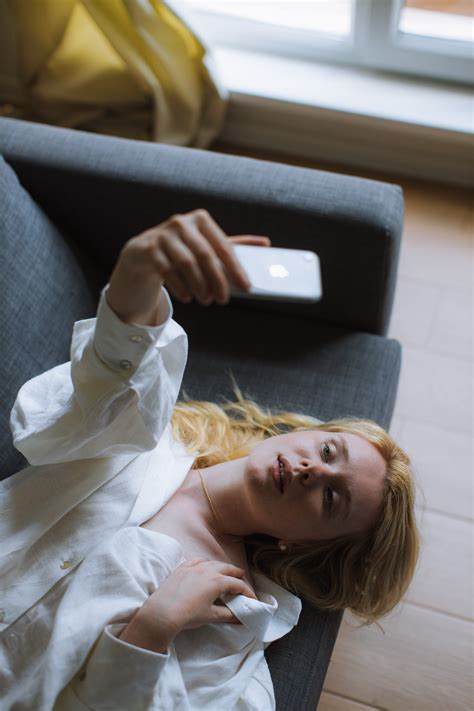 Woman In White Dress Shirt Lying On A Couch · Free Stock Photo