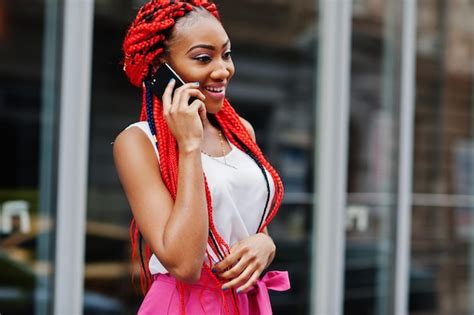 free photo fashionable african american girl at pink pants and red dreads posed outdoor with