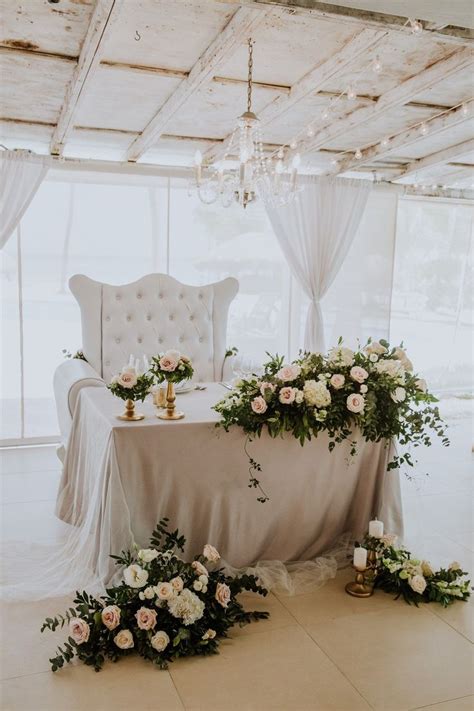 Exquisite Sweetheart Table With A Sofa And Gorgeous Flower Arrangements