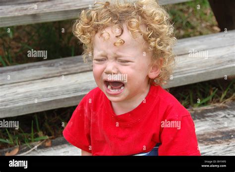 Young Boy Crying By Steps Stock Photo Alamy