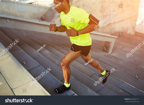 Cropped Shot Male Dark Skinned Athlete Running Up A Flight Of Stairs