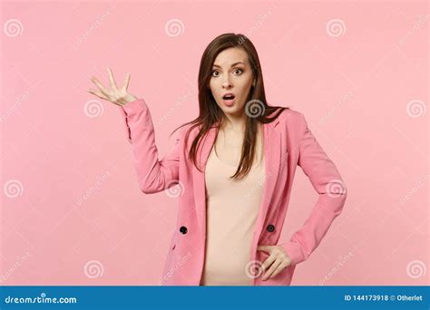 Portrait Of Shocked Bewildered Young Woman Wearing Jacket Looking Camera Spreading Hands On