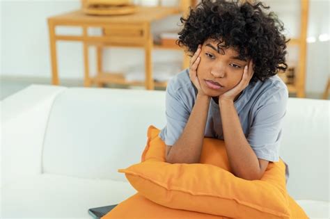 Premium Photo African American Sad Thoughtful Pensive Unmotivated Girl Sitting On Sofa At Home