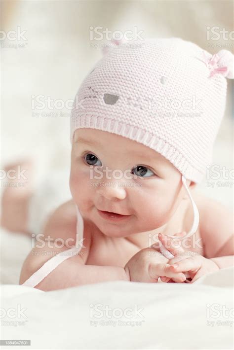 Newborn Baby Girl In Pink Knitted Hat On A Bed Stock Photo Download