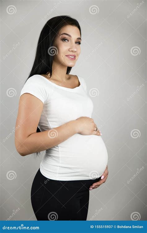 Beautiful Pregnant Brunette Woman Holding Her Pregnant Belly With Love