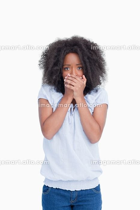 Young Woman Placing Her Hands On Her Mouth As An Indication Of Surprise