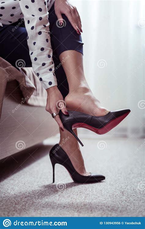 Busy Businesswoman Taking Off Her High Heeled Shoes After Long Hard Day