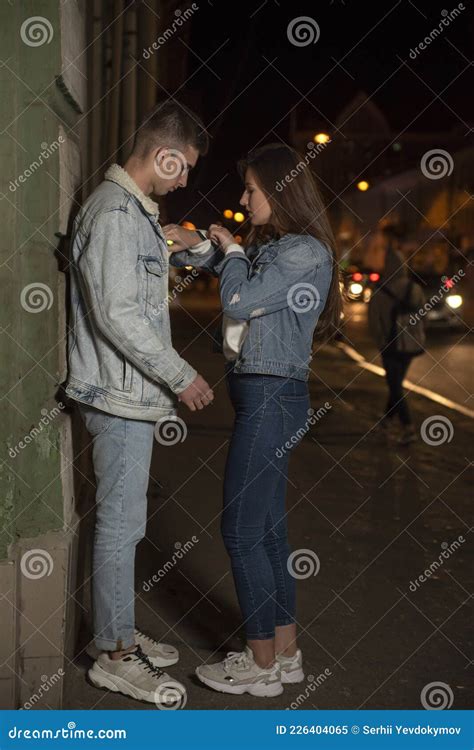 Lovers Guy And Girl In The Alley In The Evening Girl Looks At The Time And Hurries Home End Of