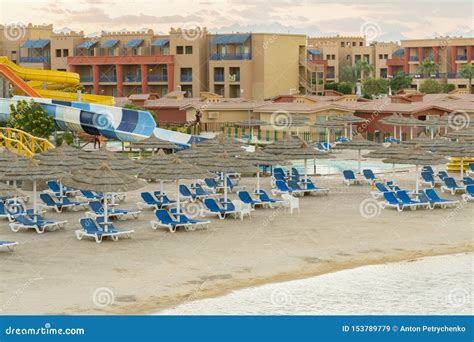 Umbrellas And Chaise Lounges On The Beach Scenic View Of Private Sandy Beach With Sun Beds From