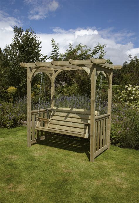Relaxing in the garden near wooden house. Anchor Fast Devon Swing Arbour - Simply Wood