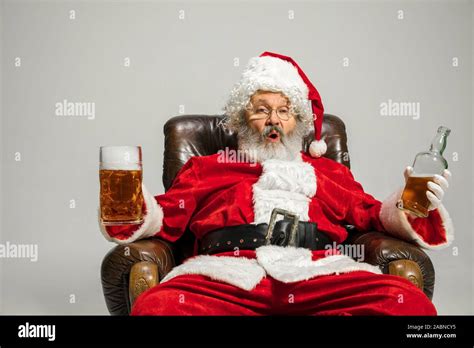 Santa Claus Drinking Beer Sitting On Armchair Congratulating Looks