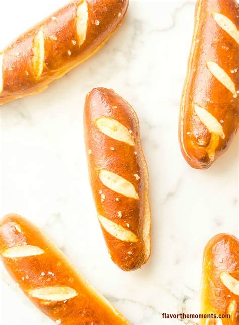 Starting at one end of the hot dog, wrap the dough strip around the hot dog leaving about ½ inch of hot dog exposed at each end. soft-pretzel-hot-dog-buns2 flavorthemoments.com - Flavor the Moments