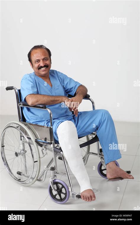Portrait Of A Man With Broken Leg Sitting In Wheelchair Stock Photo Alamy