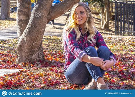 A Lovely Blonde Model Enjoys An Autumn Day Outdoors At The Park Stock
