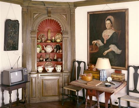 A Living Room Filled With Furniture And A Painting On The Wall Above A