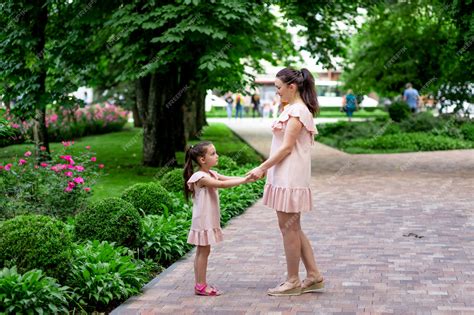 Premium Photo Happy Mother And Daughter 5 6 Years Old Walk In The Park In The Summer Mother