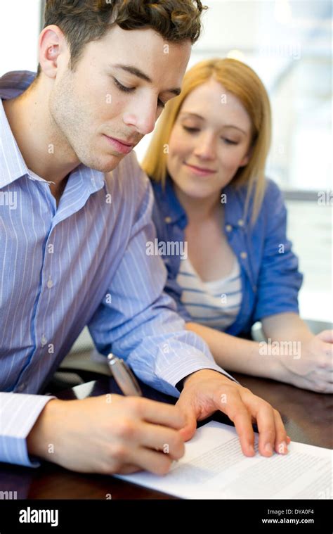 Man Signing Paperwork In Office Stock Photo Alamy