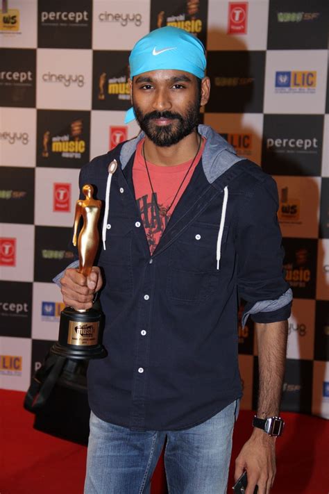 Kolaveri D Fame Singer Actor Dhanush Posing With His Award Trophy At Mirchi Music Awards 2012 In