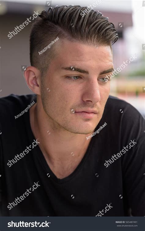 Young Handsome Man Looking Down While Stock Photo Edit Now 565487491