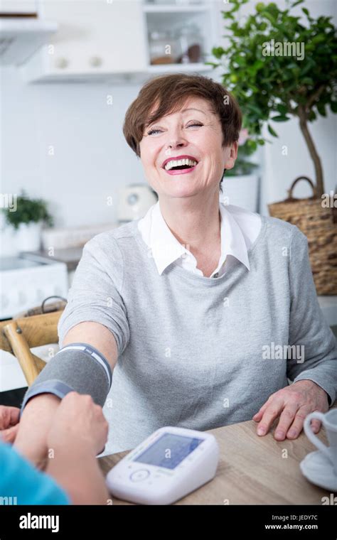 Gereatric Nurse Measuring Blood Pressure Of Patient Stock Photo Alamy