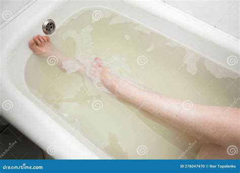 Slender Female Legs Lie Under Water In A Bathtub With Soapy Foam Image