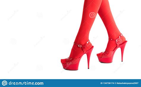 female legs in fetish red stockings and red high heels isolated on white christmas and new