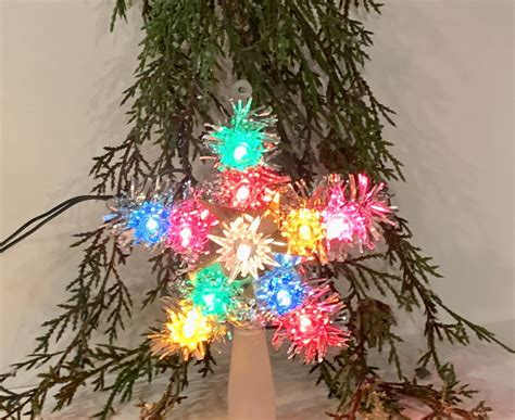 Small star tree topper multicolored lights silver tinsel