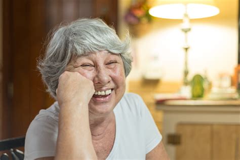 Senior Lady Laughing Out Loud At Home Stock Photo Download Image Now